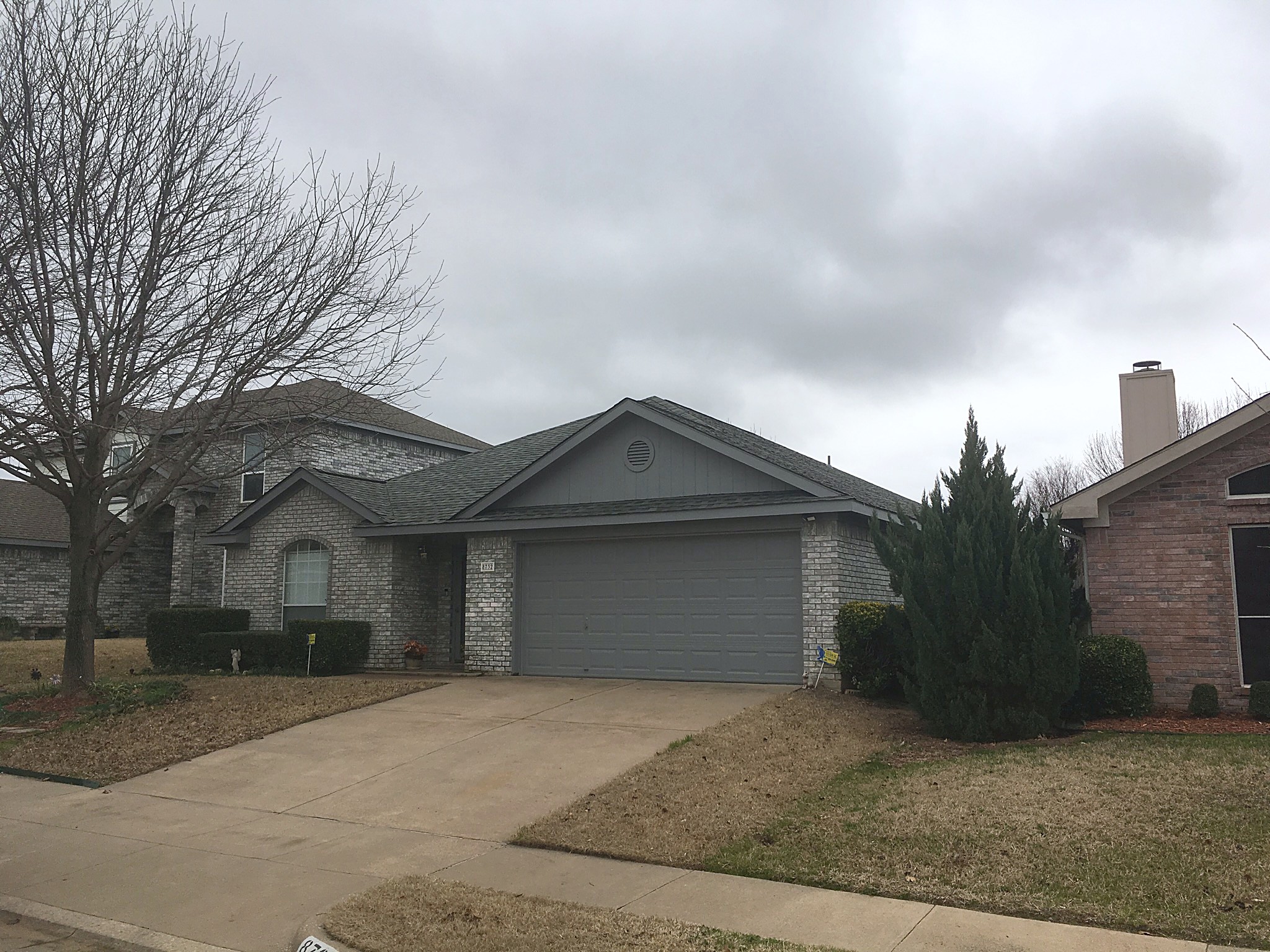 A single-story home with a finished roof on an overcast day